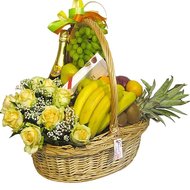 Basket with fruit, flowers and champagne