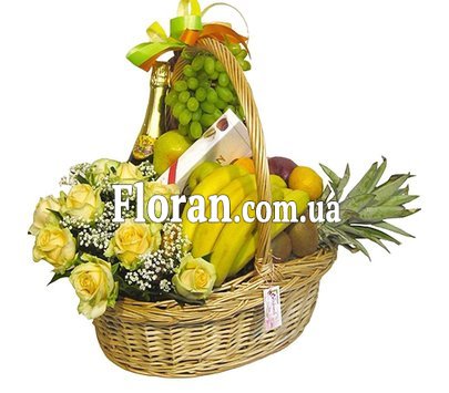 Basket with fruit, flowers and champagne
