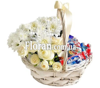 Basket with sweets and flowers