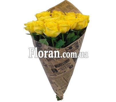 Bouquet of yellow roses in a newspaper